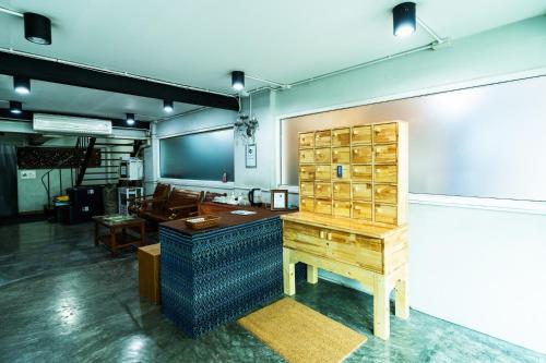 a large room with a desk and a table at XX GO INN Khaosan BKK - โกอินน์ ข้าวสาร Pro in Bang Bua Thong Railway Station