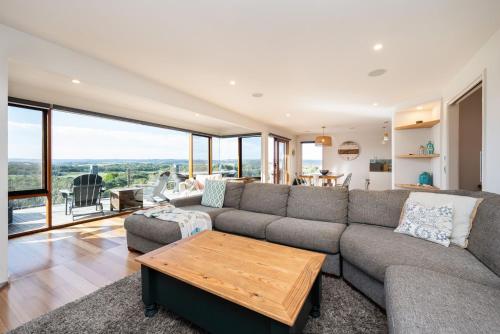 a living room with a couch and a table at Hopewell House with Spa and Golf Course Views in Saint Andrews Beach