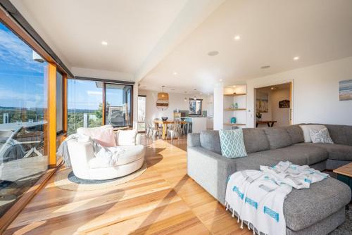 a living room with a couch and a table at Hopewell House with Spa and Golf Course Views in Saint Andrews Beach
