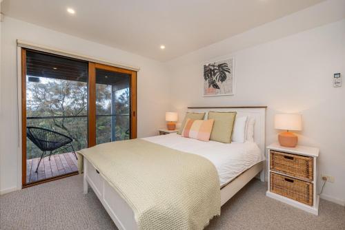a bedroom with a bed and a large window at Hopewell House with Spa and Golf Course Views in Saint Andrews Beach