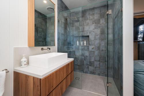 a bathroom with a sink and a shower at Hopewell House with Spa and Golf Course Views in Saint Andrews Beach