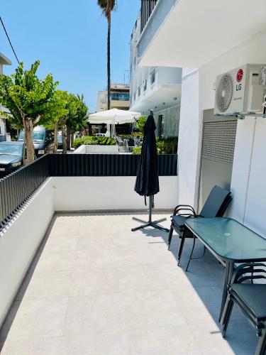 a patio with a table and chairs and an umbrella at The 52 Spot in Kos Town