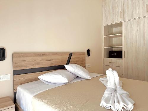a bedroom with a bed with white sheets and pillows at The 52 Spot in Kos Town