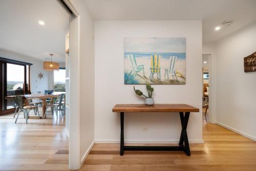 a dining room with a table and a painting on the wall at Hopewell House with Spa and Golf Course Views in Saint Andrews Beach