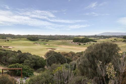 a view of a golf course with trees in the foreground at Hopewell House with Spa and Golf Course Views in Saint Andrews Beach