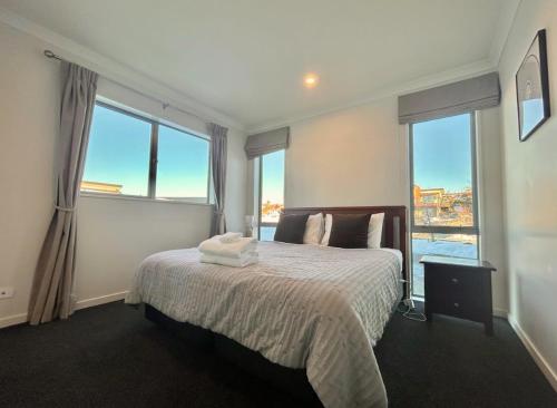 a bedroom with a bed with two towels on it at Supernova B -2 Bedrooms in Lake Tekapo
