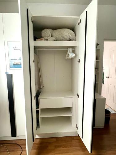 a closet with white shelves and a stuffed animal at LovelyPhimHousE in Ban Nong Khwang Tawan