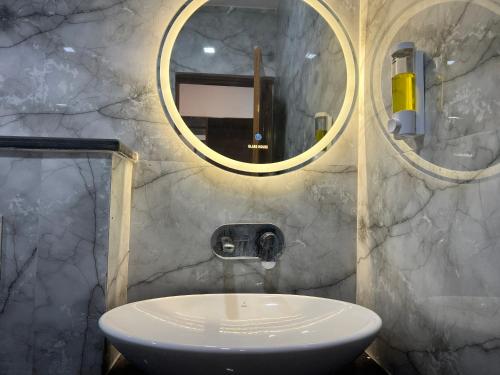 a bathroom with a sink and a mirror at The Shalam Resort श्रीकृष्ण शरणं मम in Lansdowne