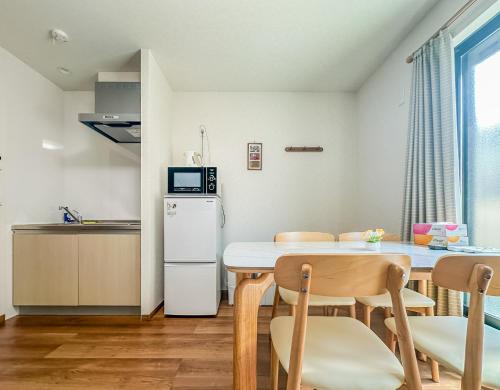 a kitchen and dining room with a table and chairs at HANASTAY花渓居 · 川（KAWA） in Osaka