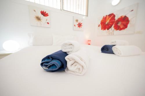 a bedroom with towels on a white bed at Seagulls melody C-209 in Adeje