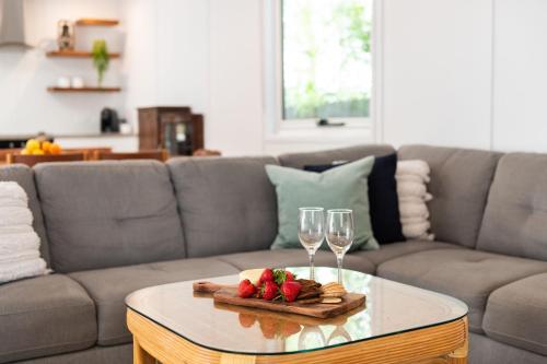 a coffee table with two wine glasses and strawberries on it at The Manyana Getaway in Manyana