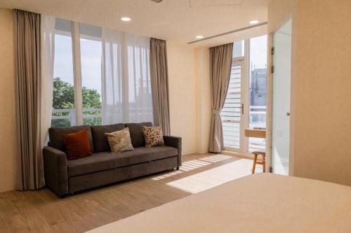 a living room with a couch and a large window at 七之二民宿 in Hengchun South Gate