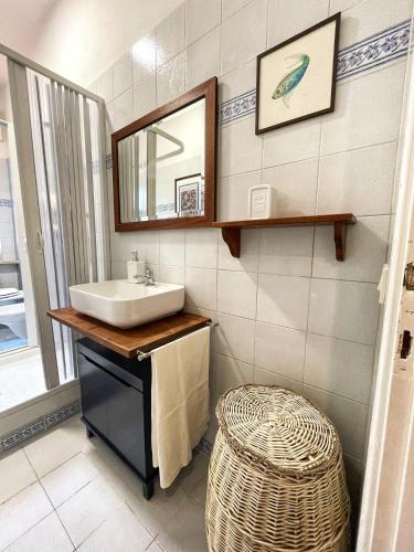 a bathroom with a sink and a mirror and a stool at Villa Simonetta in Castellina Marittima