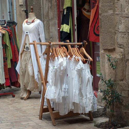 a display of dresses on a rack in a store at L'Atelier, Confort, Bain à remous et Nature in Parisot-Tarn-et-Garonne