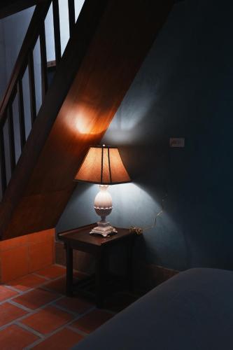 a lamp sitting on a table under a staircase at 牧嶼 Nomads' Isle in Jinhu