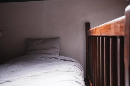 a bed with a wooden headboard in a bedroom at 牧嶼 Nomads' Isle in Jinhu