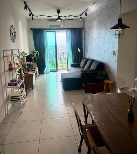 a living room with a couch and a table at Meritus Suites - 8pax in Perai