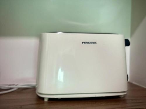 a white printer sitting on top of a wooden table at Meritus Suites - 8pax in Perai