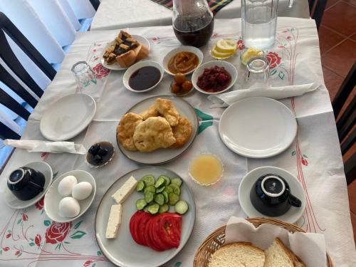 a table with plates of food on a table at Hotel Dini in Vlorë
