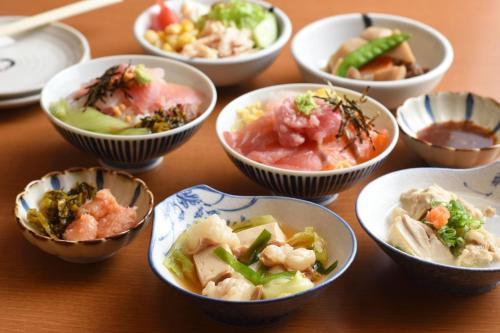 a group of bowls of food on a table at Hakata Green Hotel Annex in Fukuoka