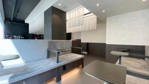 a kitchen with a counter with a bench and a table at GOYOO INN & cabins in Seoul