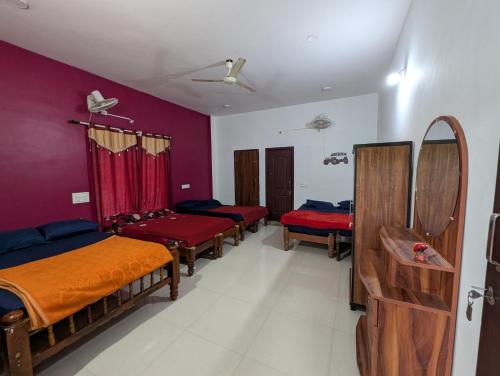 a room with four beds and a mirror at Rasta Homestay Sakleshpur in Sakleshpur