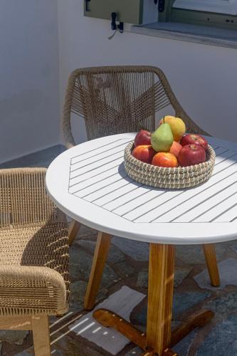 a bowl of fruit sitting on a table at Elena Studios & Apartments in Piso Livadi