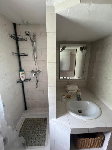 une salle de bain blanche avec un lavabo et une douche dans l'établissement Maison à 20minutes de Nice, à Tourrette-Levens