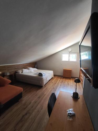 a room with a bed and a table in it at La Cubertilla en Madrid in Navas del Rey