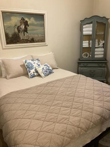 a bedroom with a bed with a painting on the wall at The Central Hotel OF 1910 in Buffalo