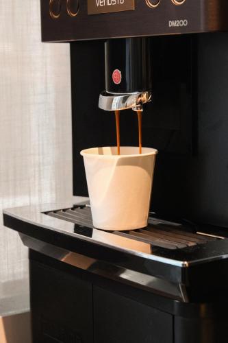 a coffee maker sitting on top of a coffee pot at GOYOO INN & cabins in Seoul
