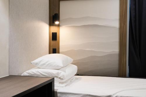 a bedroom with a view of a bed with pillows at GOYOO INN & cabins in Seoul