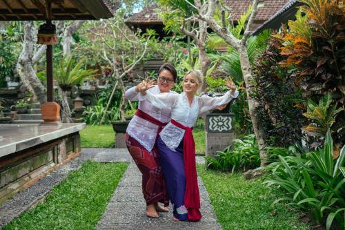 two women posing for a picture in a garden at Mumbul Ubud in Ubud