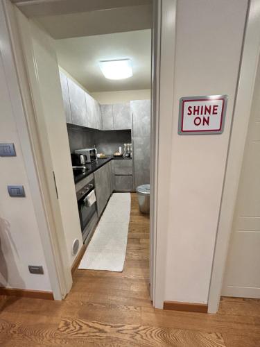 a small kitchen with a sign that reads shine on at Bon Bon Cavour in Asti
