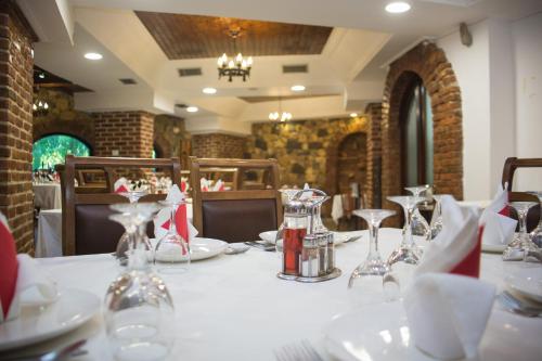 a table in a restaurant with a white table cloth at Hotel Livia in Ksamil