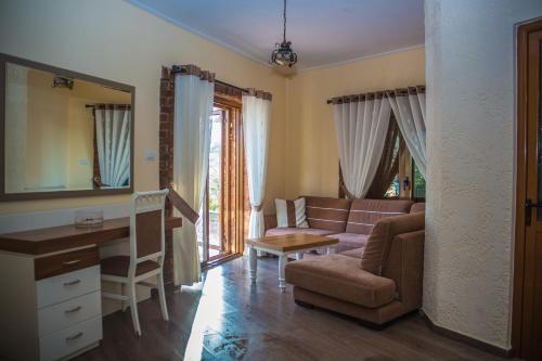 a living room with a couch and a table at Hotel Livia in Ksamil