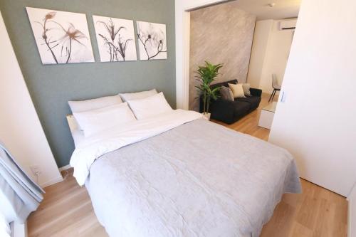 Postel nebo postele na pokoji v ubytování フォルモント寺田町 203