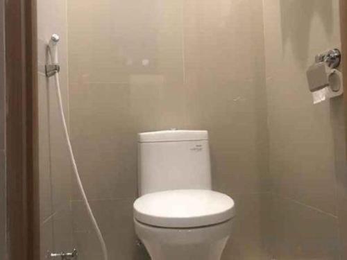 a bathroom with a white toilet in a stall at InnBox Capsule Hotel in Jember
