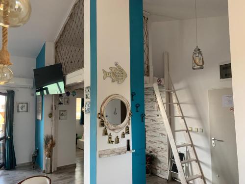 two views of a room with a staircase and a mirror at Seaview Young Family - Семейство на Черно море in Aheloy