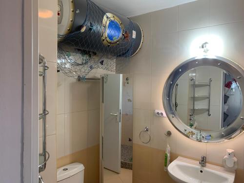 a bathroom with a sink and a mirror at Seaview Young Family - Семейство на Черно море in Aheloy