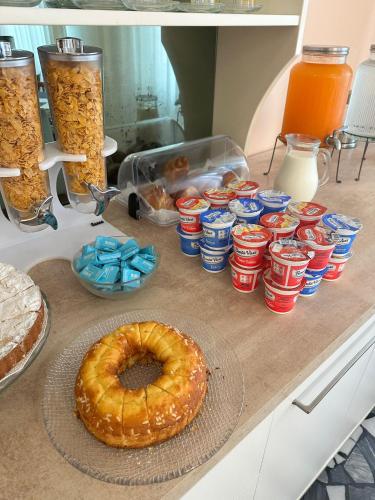 a table with a donut and a bunch of canned food at Hotel Enna Rimini in Rimini