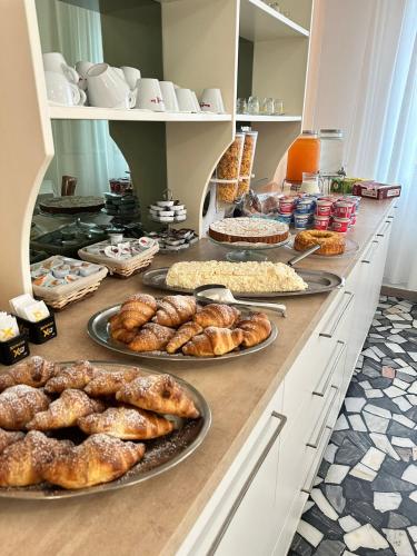 a buffet with many different types of bread and pastries at Hotel Enna Rimini in Rimini