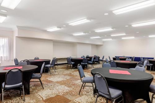 an empty room with tables and chairs in it at Quality Inn & Suites Denver Airport - Gateway Park in Aurora
