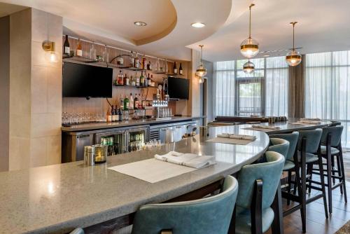 a bar with bar stools at a restaurant at Cambria Hotel Madison East in Madison