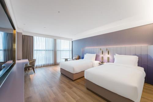 Postel nebo postele na pokoji v ubytování Manxin Hotel Guangzhou Baiyun Airport Branch