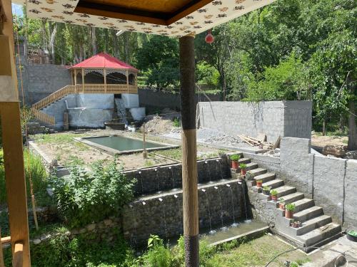 a backyard with a pond and a gazebo at Brookfall resort khaplu in Khaplu