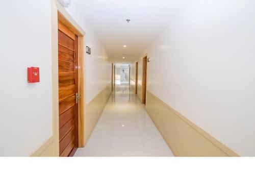 an empty hallway with a door and a long corridor at Hotel Lapira Vigan in Vigan