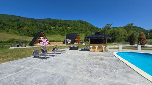 a resort with a swimming pool and a gazebo at Etno Selo RELAX in Šipovo