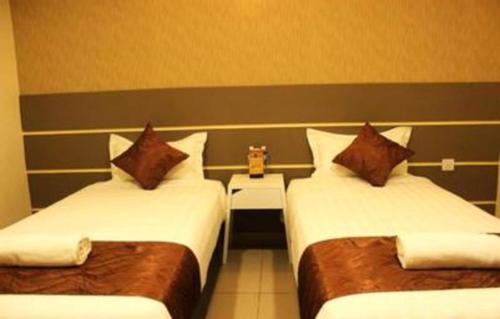 a hotel room with two beds with pillows at Rock & Roll Hotel Klang in Klang