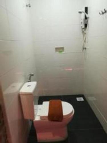 a bathroom with a pink toilet and a sink at Rock & Roll Hotel Klang in Klang